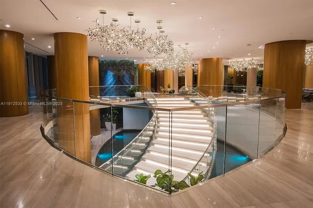 a view of a dining room with furniture a chandelier and wooden floor