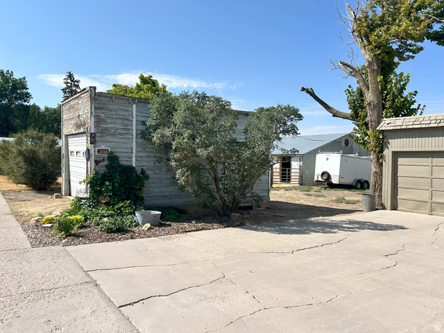 40 South State Street Scipio, UT 84656 - Photo 27 of 39 View of property exterior featuring a garage, driveway, and an outbuilding
