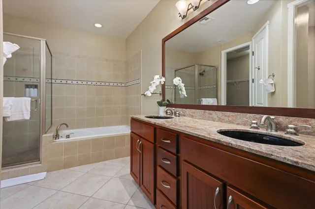 a spacious bathroom with a tub sink and mirror