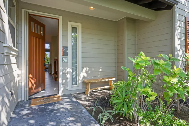 a backyard of a house with outdoor seating