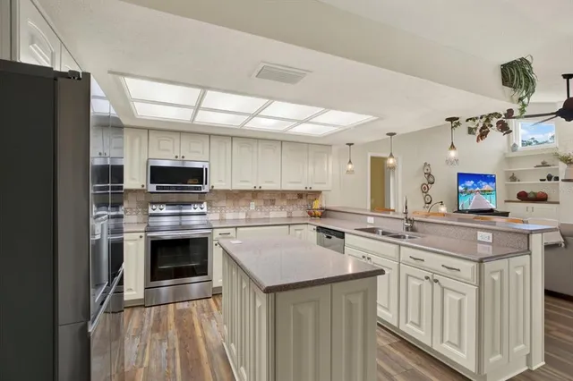 a kitchen with a sink stove and refrigerator