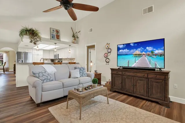 a living room with furniture a rug and a flat screen tv