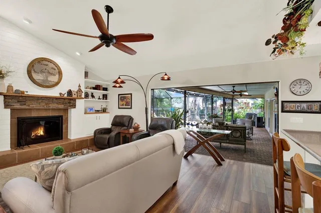 a living room with furniture a clock and a fireplace