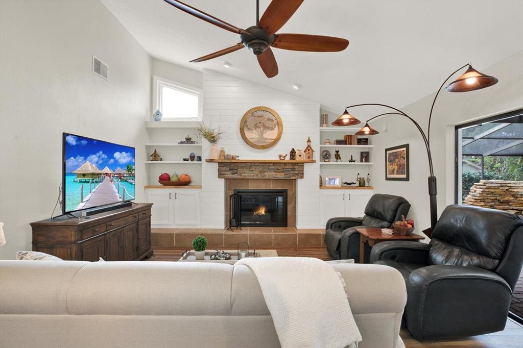 2806 Fairway View Drive Valrico, FL 33596 - Photo 24 of 45 a living room with furniture a clock and a fireplace