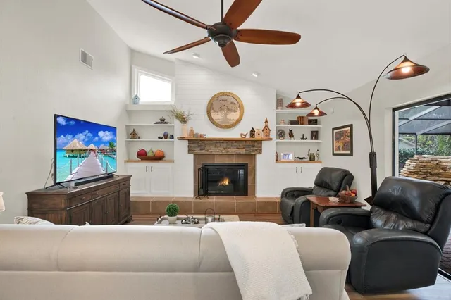 a living room with furniture a clock and a fireplace