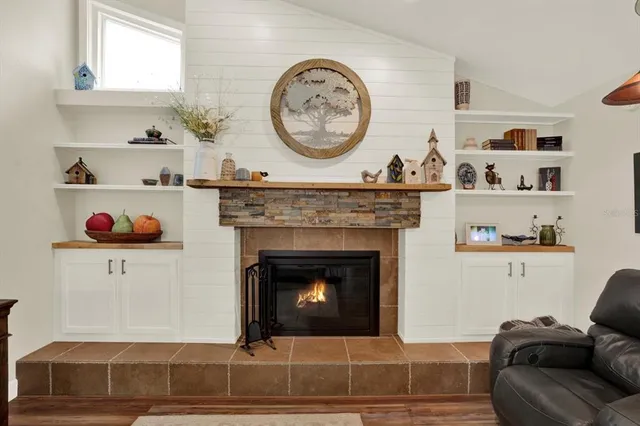 a living room with a clock and a fireplace