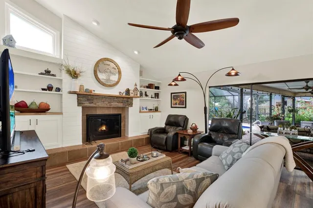 a living room with furniture a clock and a fireplace