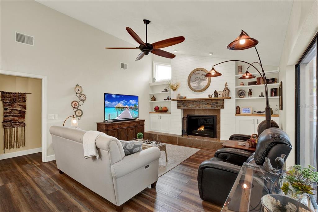 2806 Fairway View Drive Valrico, FL 33596 - Photo 27 of 45 a living room with furniture a fireplace and wooden floor