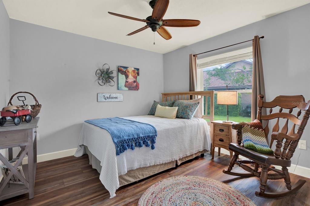 2806 Fairway View Drive Valrico, FL 33596 - Photo 32 of 45 a bedroom with a bed a chair and a large window