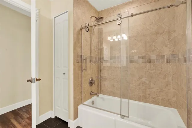 a bathroom with a shower and a tub