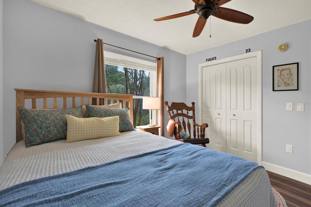 2806 Fairway View Drive Valrico, FL 33596 - Photo 33 of 45 a bedroom with a bed and a chandelier