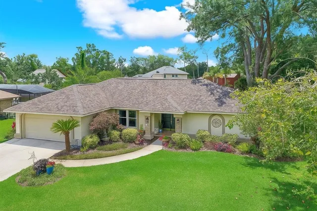 a front view of a house with a garden and outdoor seating