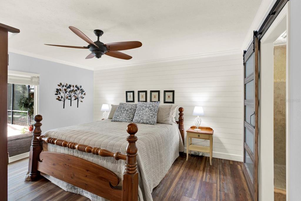 2806 Fairway View Drive Valrico, FL 33596 - Photo 10 of 45 a bedroom with a bed and wooden floor