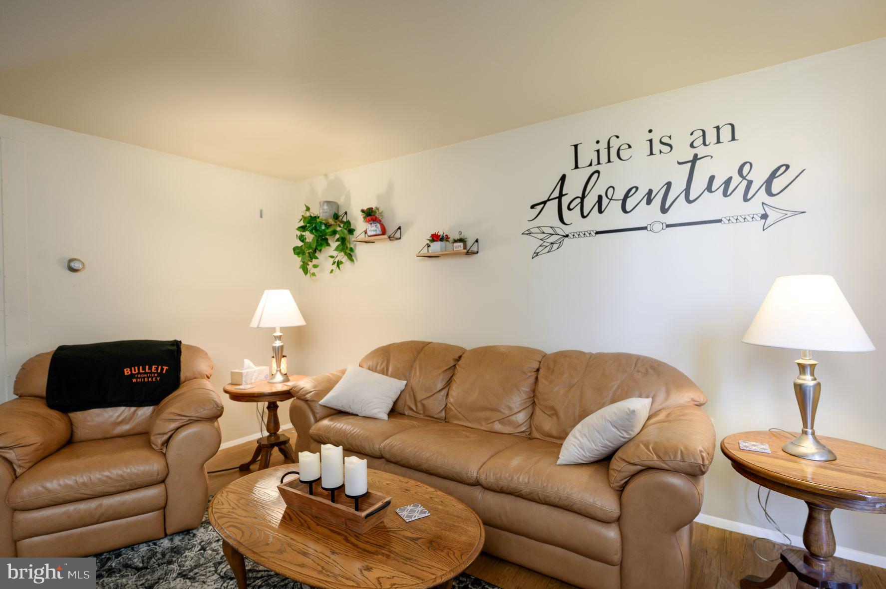 137 Roberta Jean Avenue Littlestown, PA 17340 - Photo 4 of 8 a living room with furniture and a lamp