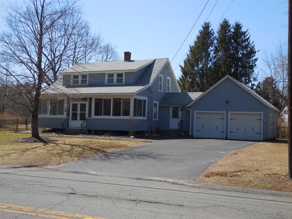 36 East Leverett Road Amherst, MA 01002 - Photo 2 of 18 a front view of a house with a yard and garage