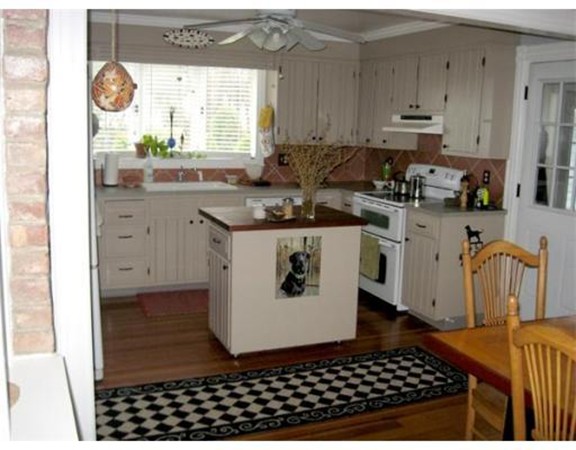 36 East Leverett Road Amherst, MA 01002 - Photo 3 of 18 a kitchen with a sink a stove a refrigerator and cabinets