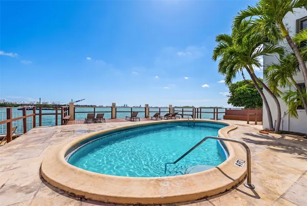 a view of a swimming pool with a lounge chair