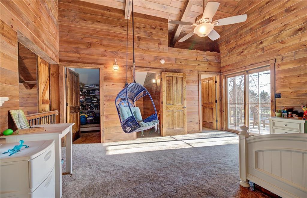 122 Klein Road Cranberry Township, PA 16066 - Photo 15 of 25 16x15 upper level bedroom with full ensuite, walk-in closet, 16' cathedral ceiling, Pella sliders to a private waterproof aluminum deck, barn doors overlooking rustic family room, ceiling fan and separate air/heat system.