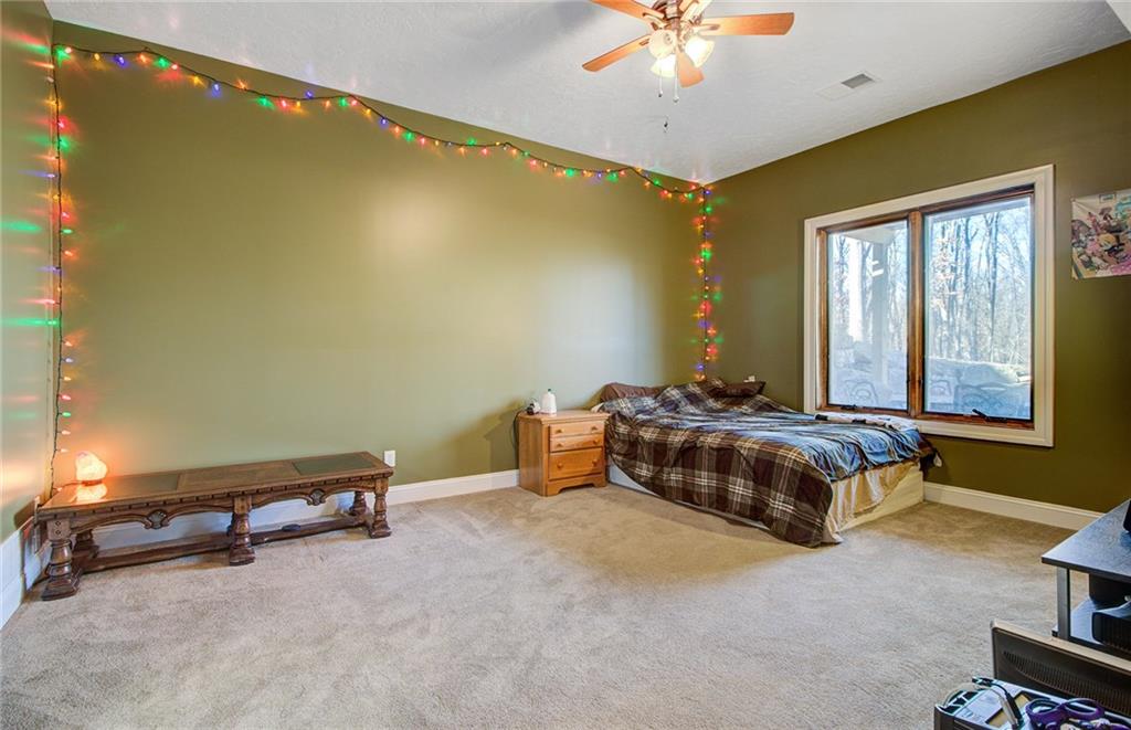 122 Klein Road Cranberry Township, PA 16066 - Photo 20 of 25 16x13 LL bedroom with egress windows, trim, ceiling light/fan and wall to wall carpeting.
