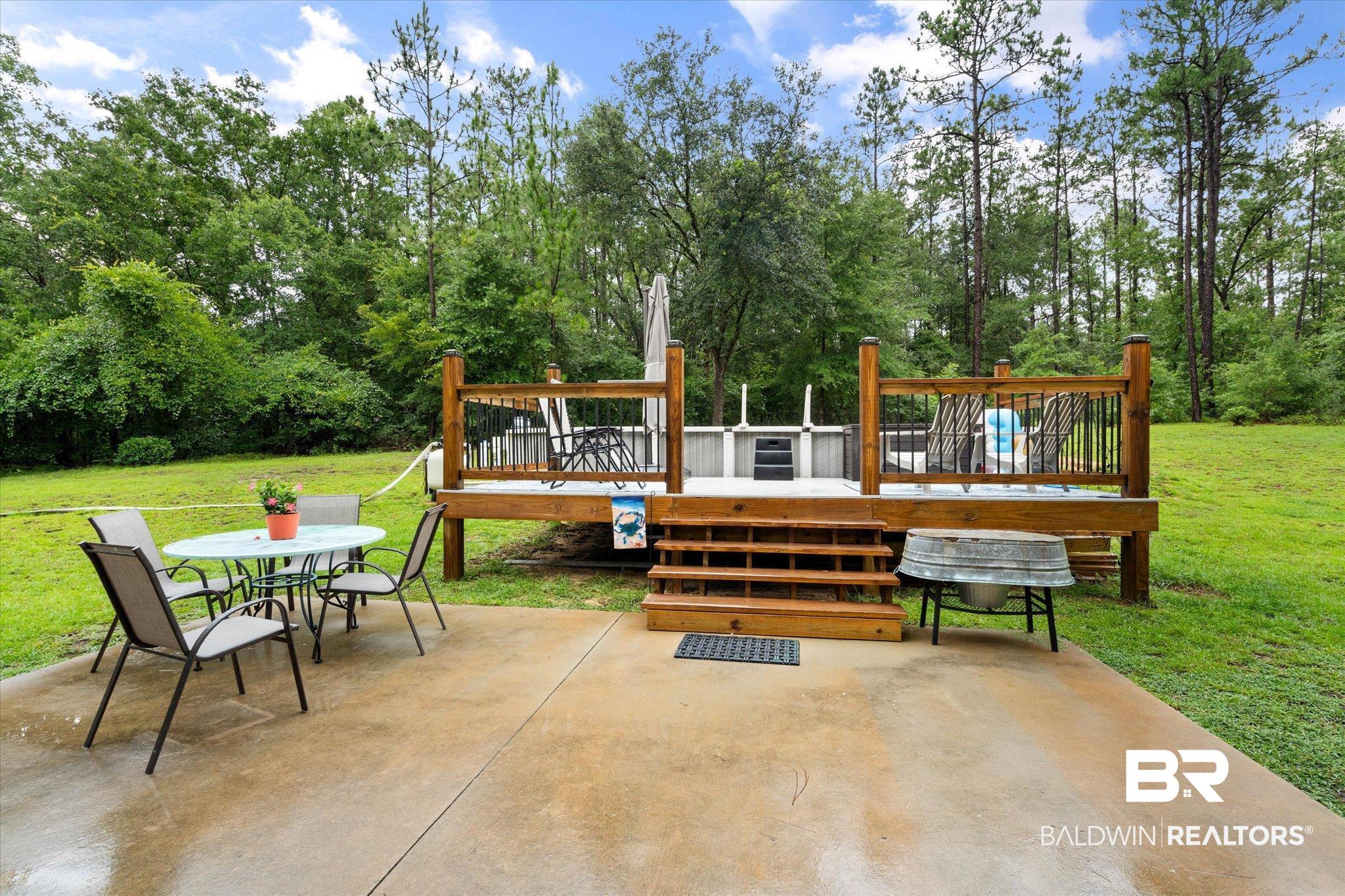 2300 Radcliff Road Saraland, AL 36571 - Photo 36 of 56 View of patio / terrace with outdoor dining area, a deck, and view of scattered trees