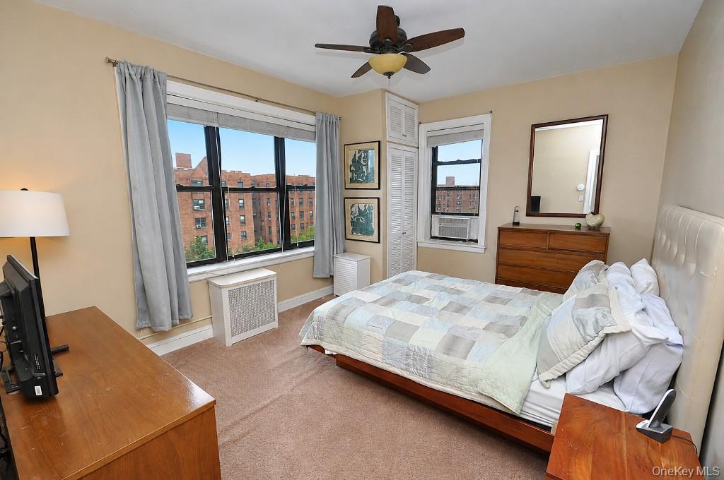 143 Garth Road, Unit 5J Scarsdale, NY 10583 - Photo 4 of 47 a bedroom with a bed dresser and a window
