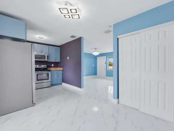 a kitchen with stainless steel appliances granite countertop a refrigerator stove and microwave