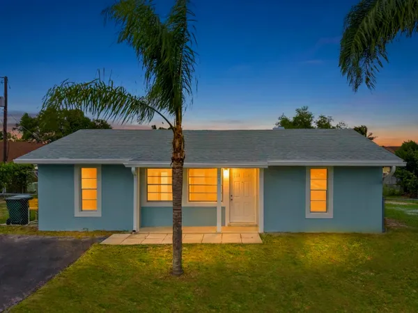 a house that has a tree in front of it