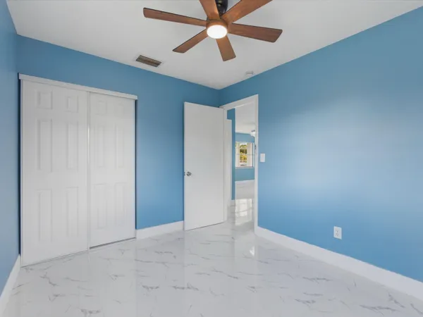 a view of room with window and ceiling fan