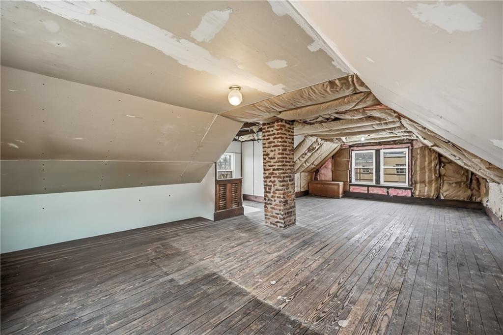 564 Spruce Avenue Sharon, PA 16146 - Photo 27 of 37 an empty room with wooden floor and stairs