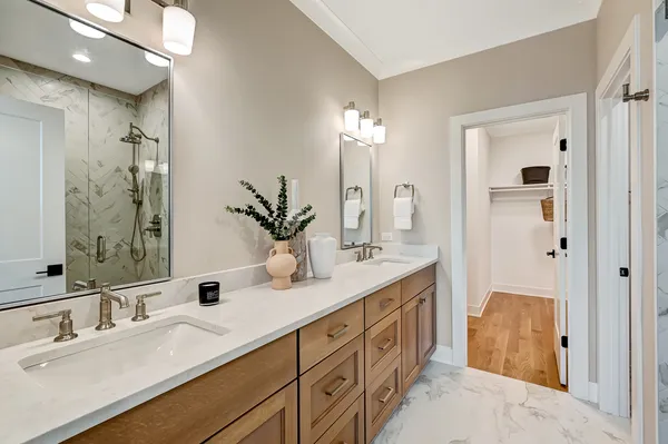 a spacious bathroom with double sink and a mirror