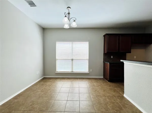 a view of an empty room with a kitchen