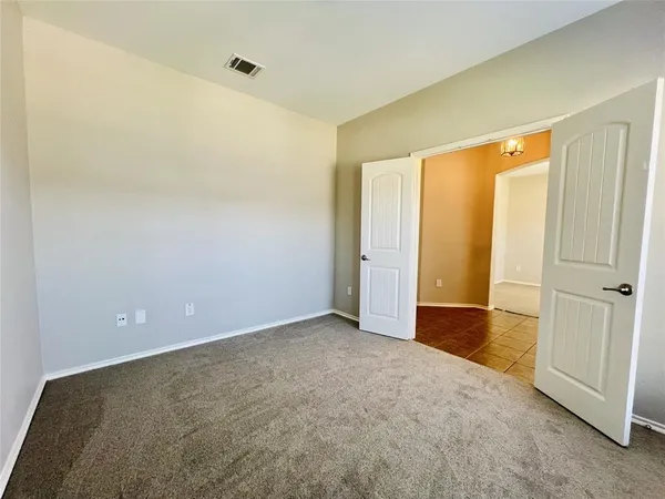 an empty room with closet area