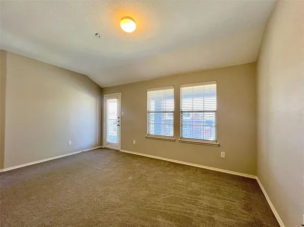 an empty room with a empty space and windows