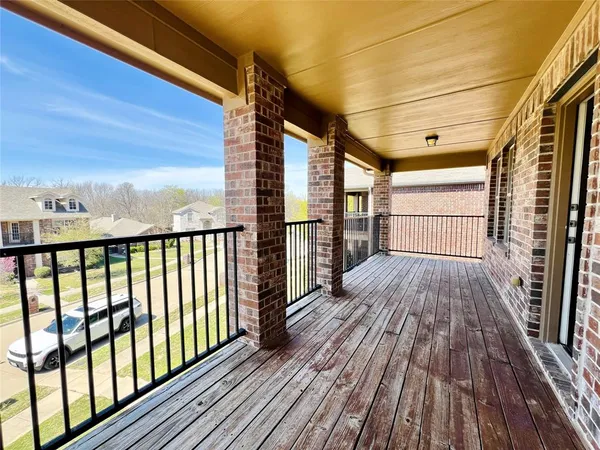 a view of a balcony with wooden floor