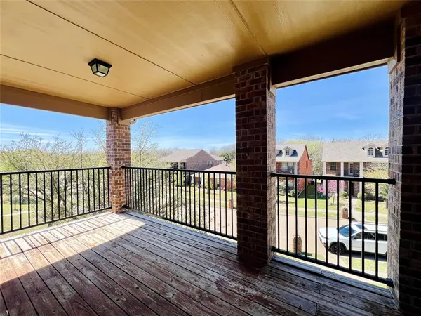 a view of a porch with wooden floor