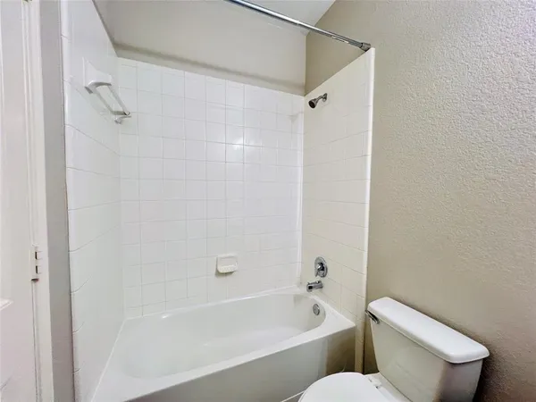 a bathroom with a toilet and a bathtub