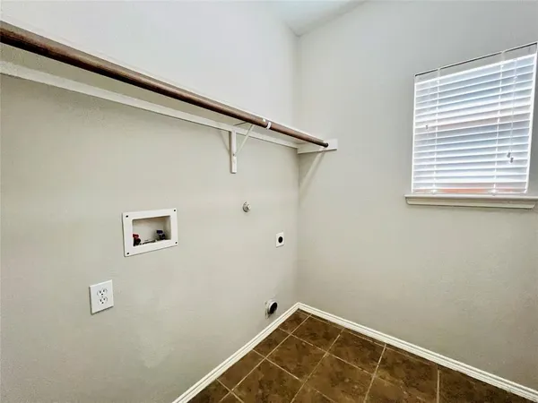 a view of a room with rack on the wall and a window