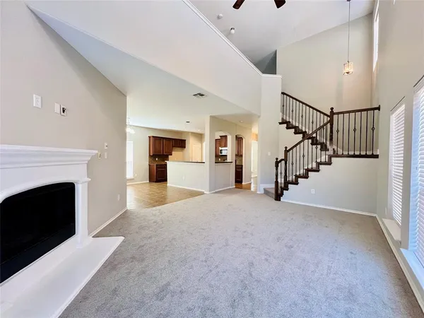 a view of a livingroom with a fireplace and staircase