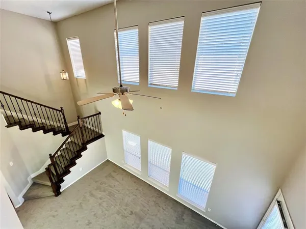 a view of staircase with white walls and a window