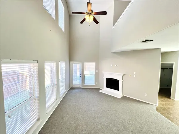 a view of a livingroom with a fireplace and window