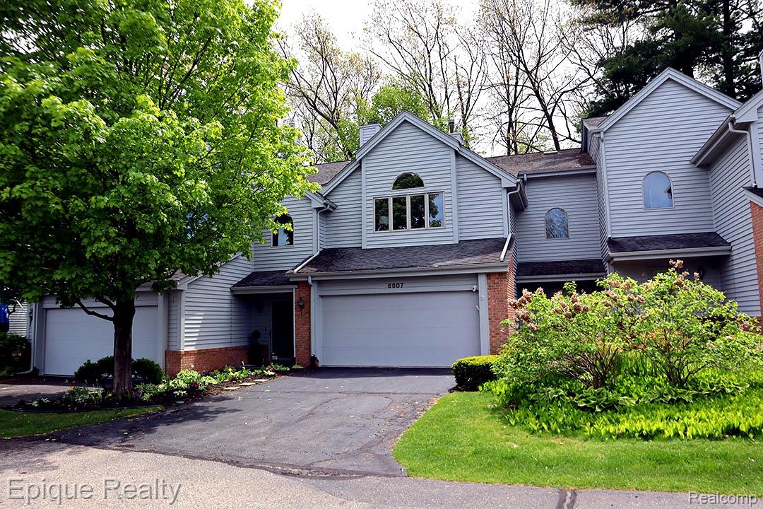 6607 Ridgeview Drive Clarkston, MI 48346 - Photo 2 of 25 Traditional home featuring brick siding, driveway, an attached garage, and roof with shingles