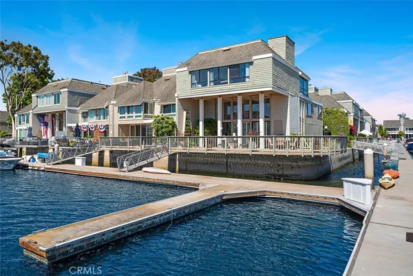 a view of a house with pool and sitting area
