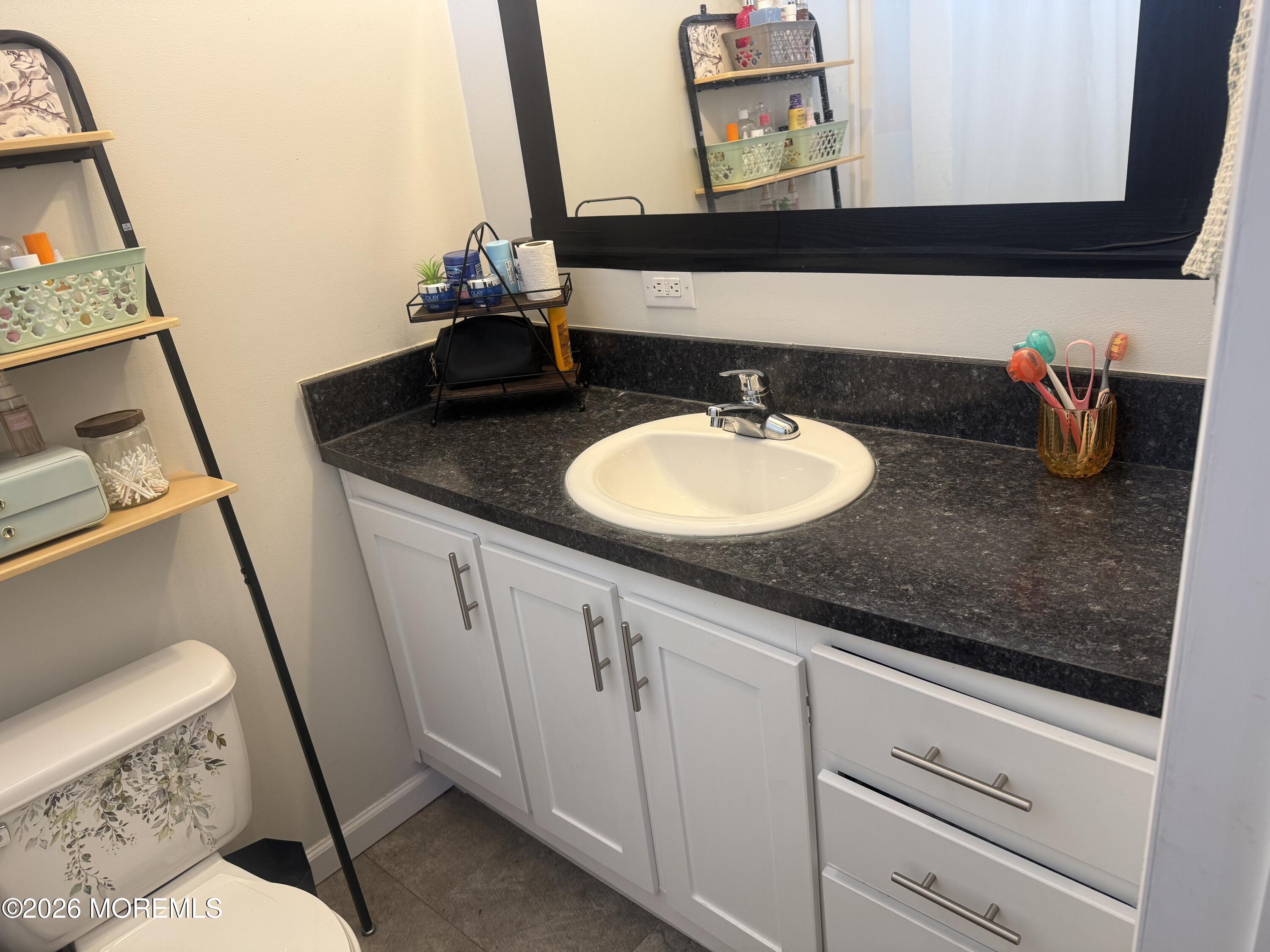 52 Monique Circle Hazlet, NJ 07730 - Photo 9 of 12 a bathroom with a sink and a mirror