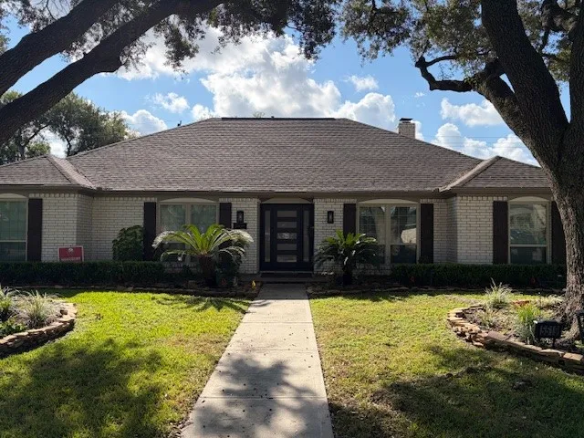a front view of a house with a yard and porch