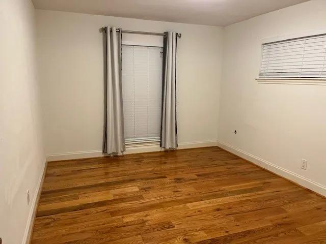 a view of room with wooden floor