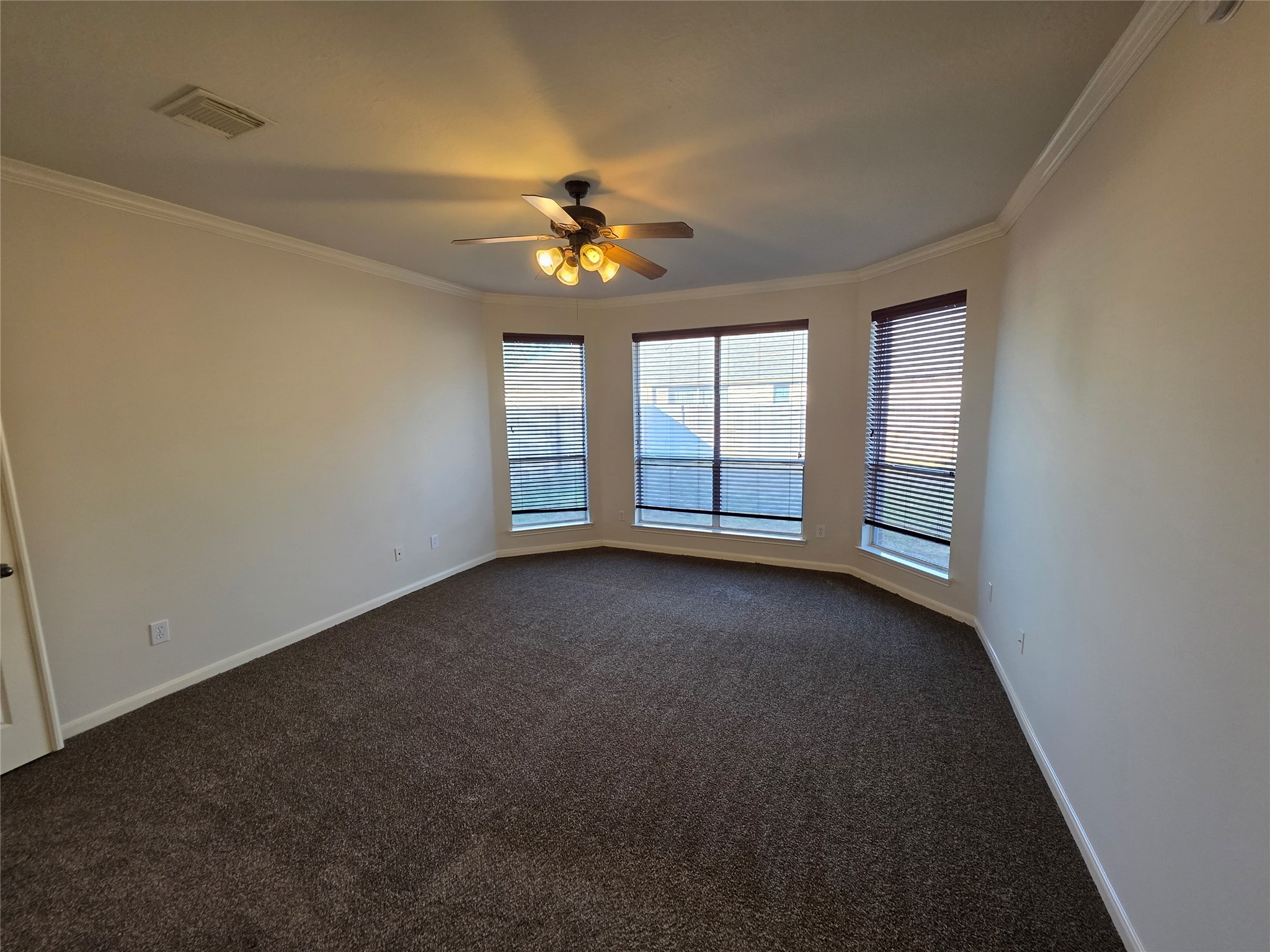 22231 Bridgestone Oak Drive Spring, TX 77388 - Photo 13 of 25 an empty room with windows and chandelier fan