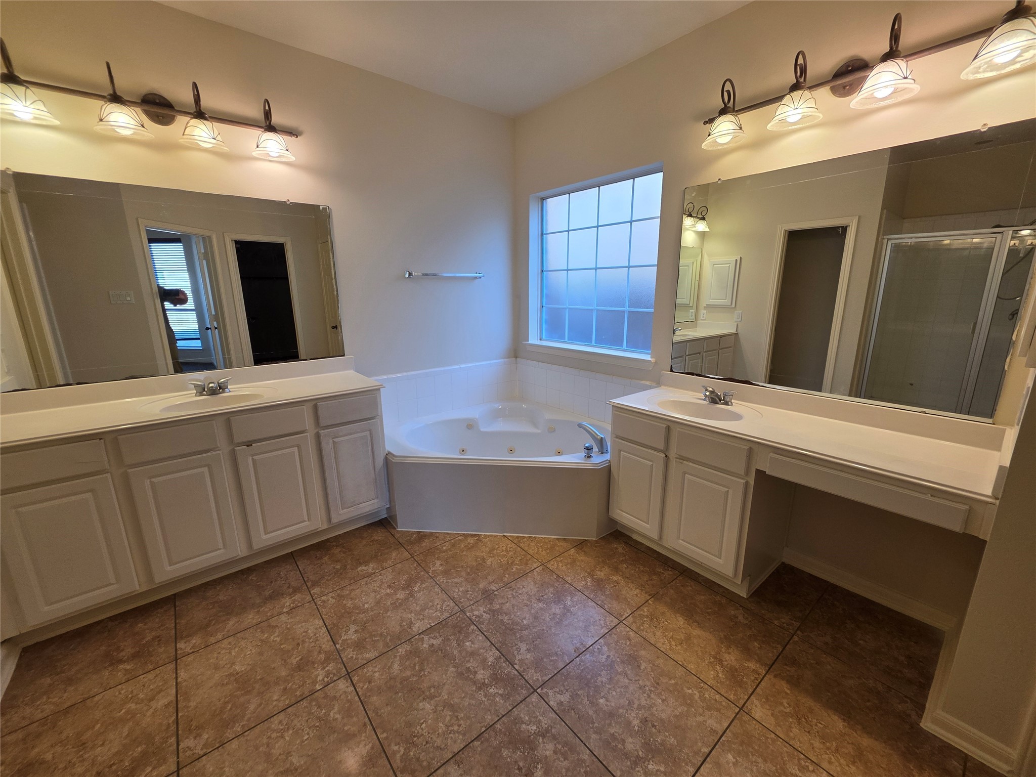 22231 Bridgestone Oak Drive Spring, TX 77388 - Photo 14 of 25 a bathroom with a double vanity sink a mirror and a bathtub