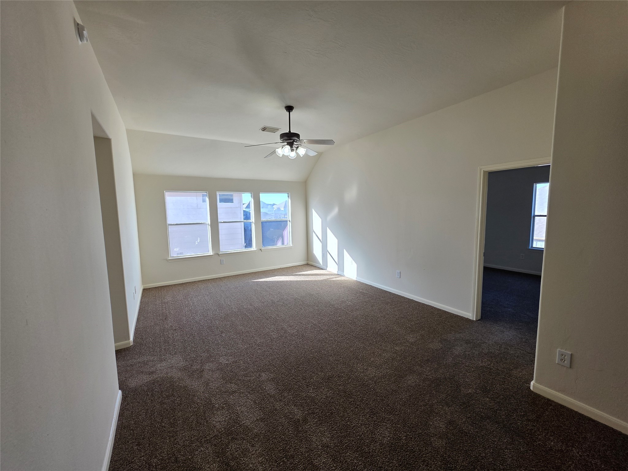 22231 Bridgestone Oak Drive Spring, TX 77388 - Photo 19 of 25 an empty room with windows and chandelier fan