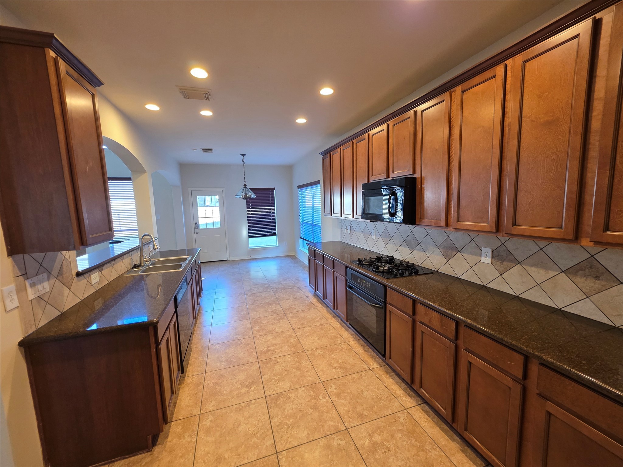 22231 Bridgestone Oak Drive Spring, TX 77388 - Photo 8 of 25 a large kitchen with stainless steel appliances granite countertop a sink and a stove