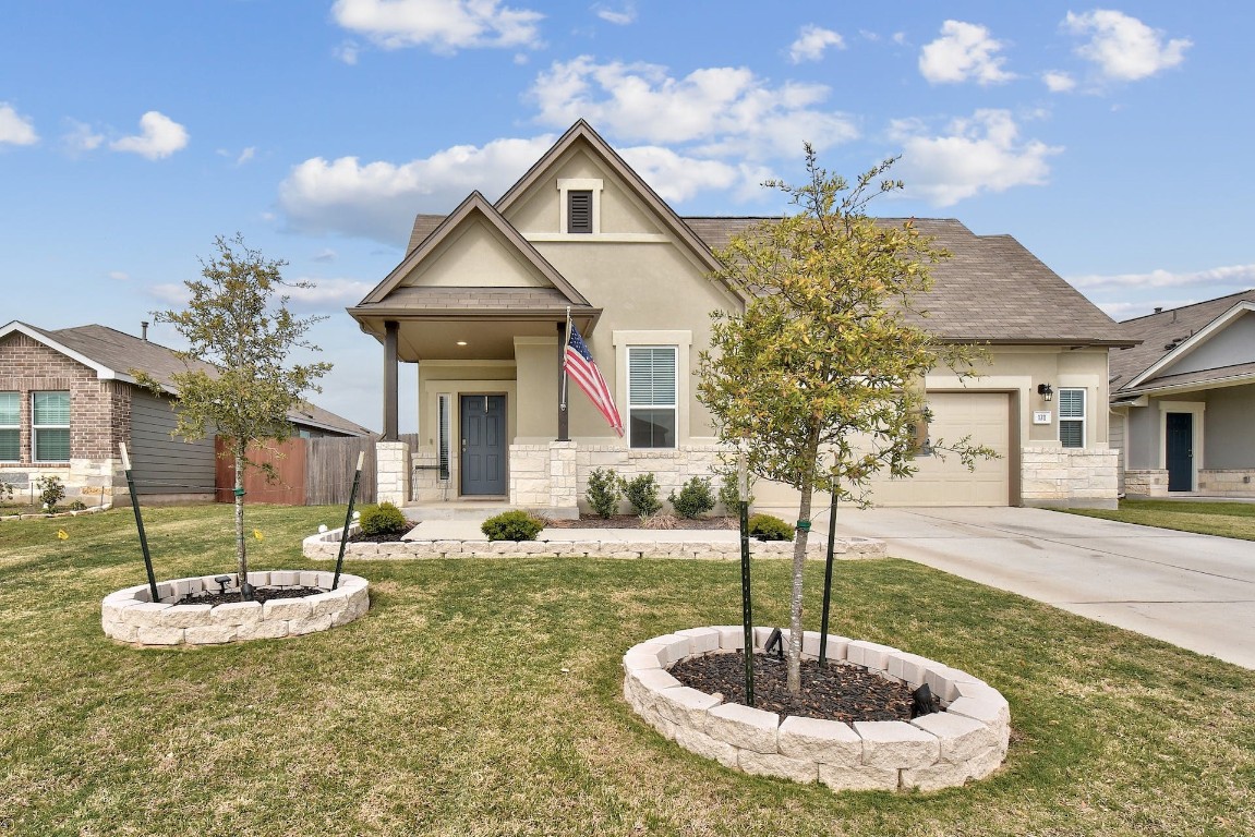 a front view of a house with garden